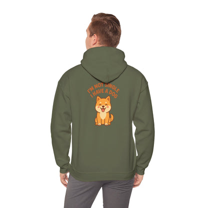 Person wearing a green hoodie with a dog graphic and text on the back