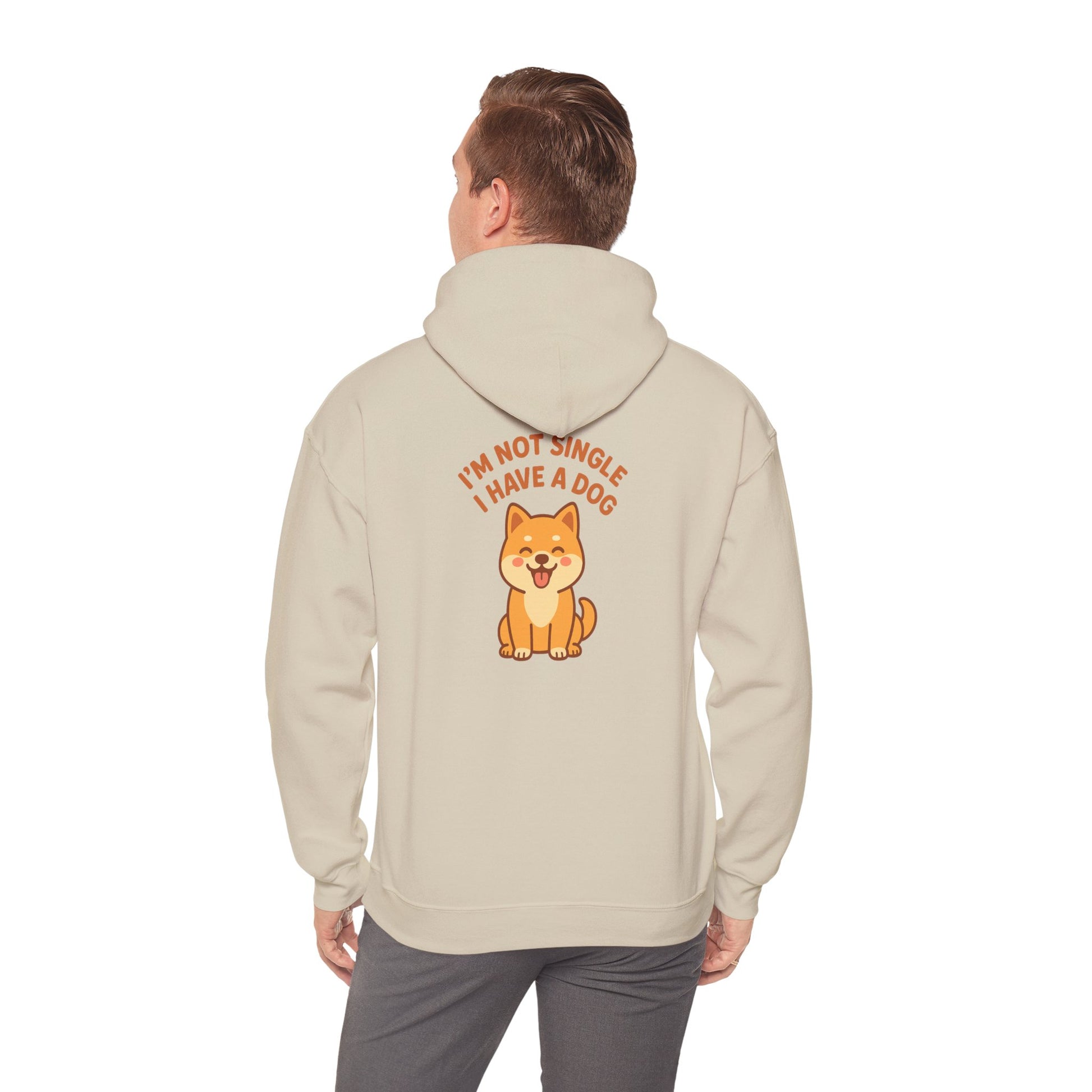 Person wearing a beige hoodie with a dog graphic and text on the back, on a white background